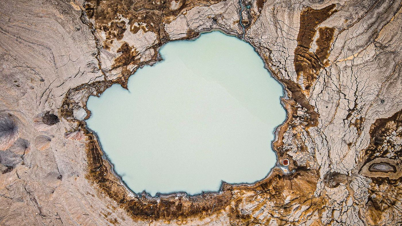 A sinkhole in the ground near Ein Gedi on the retreating Dead Sea shore