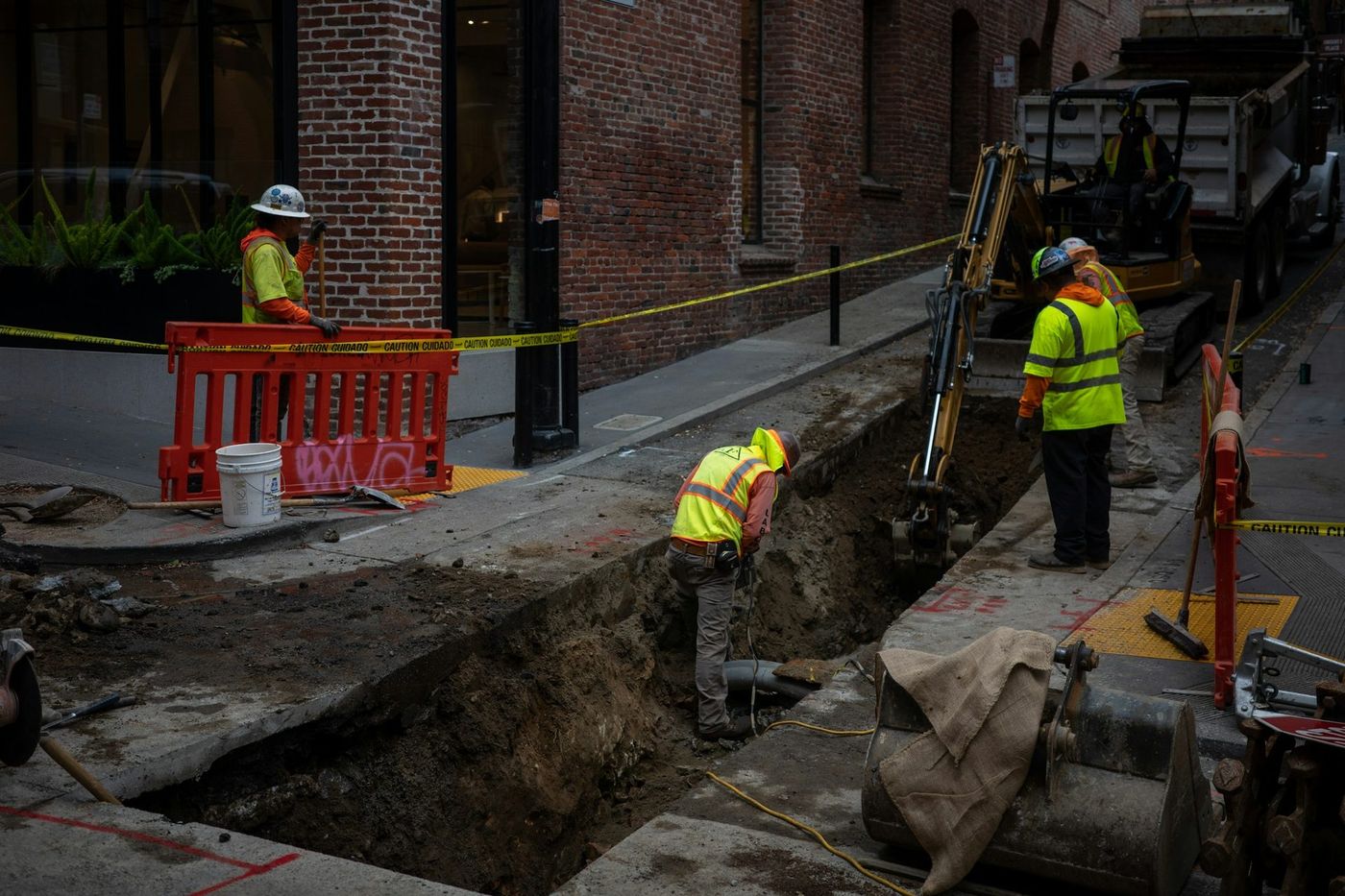 A crew working in an open trench in a city street